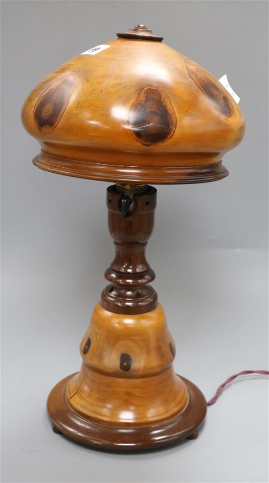 A fruitwood lamp, on circular foot, with vari baluster stem and domed wood shade, overall height 45cm